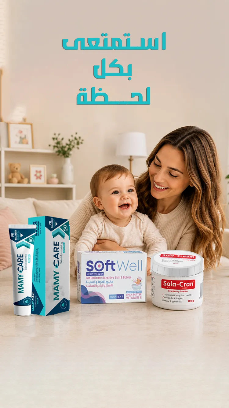 Woman holding a baby with various baby care products on a table in a home setting.